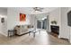 Cozy living room features sleek flooring, modern furniture, fireplace, and sliding glass doors leading to a patio at 1402 Camp Rd # 10C, Charleston, SC 29412