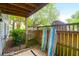 Enclosed patio with wooden fence, surfboards, a bike, and outdoor greenery at 1402 Camp Rd # 10C, Charleston, SC 29412