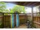 Private patio area featuring wooden fencing, surfboards, and a bicycle for outdoor enjoyment at 1402 Camp Rd # 10C, Charleston, SC 29412
