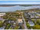 Aerial view of yellow multi-story home with red star, with waterfront and bridge in the background at 141 Beaufain St, Charleston, SC 29401