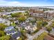 Aerial view of a yellow multi-story home with a red star, nestled in a vibrant neighborhood near a lake at 141 Beaufain St, Charleston, SC 29401