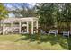 Landscaped backyard featuring a pergola, lounge seating, brick fence, and well-manicured lawn at 141 Beaufain St, Charleston, SC 29401