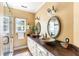 Bathroom with double sinks, granite counters, decorative mirrors, and a glass enclosed shower at 141 Beaufain St, Charleston, SC 29401
