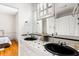 Bathroom with double sinks, black fixtures, and tile countertop and backsplash at 141 Beaufain St, Charleston, SC 29401
