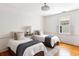Bedroom with two twin beds, hardwood floors, overhead lighting, and a window at 141 Beaufain St, Charleston, SC 29401