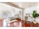Bright bedroom showcases hardwood floors, neutral tones, a cozy rug, a work nook, and French doors at 141 Beaufain St, Charleston, SC 29401