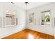 Empty bedroom with hardwood floors and three windows with shutters at 141 Beaufain St, Charleston, SC 29401