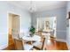 Cozy dining area with hardwood floors, chandelier, and seamless transition to the living room at 141 Beaufain St, Charleston, SC 29401