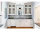 Elegant kitchen featuring white cabinets, dark countertops, and hardwood flooring at 141 Beaufain St, Charleston, SC 29401