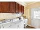 Bright laundry room with front loading washer and dryer, sink, and overhead cabinets for storage at 141 Beaufain St, Charleston, SC 29401