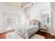Bright bedroom with neutral décor, hardwood floors, and double doors to outdoor space at 141 Beaufain St, Charleston, SC 29401