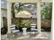Stylish outdoor patio featuring striped chairs, a unique center table, and a patterned umbrella at 141 Beaufain St, Charleston, SC 29401