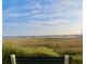 Scenic water view featuring sailboats and a vibrant marsh viewed from a bench at 141 Beaufain St, Charleston, SC 29401