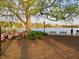 Picturesque waterfront view featuring a mature tree, benches, azalea bush, and a walking path at 141 Beaufain St, Charleston, SC 29401