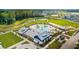 Aerial view of community pool and amenity center with a playground, walking trails, and pond at 144 Sandy Bend Ln, Summerville, SC 29486