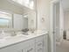 Bright bathroom featuring double sinks with white cabinets and a large mirror at 144 Sandy Bend Ln, Summerville, SC 29486