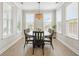 Bright dining room with large windows, a wooden table, and seating for eight at 144 Sandy Bend Ln, Summerville, SC 29486