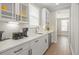 Bright kitchen showcasing white cabinets, quartz countertops, and stainless steel appliances at 144 Sandy Bend Ln, Summerville, SC 29486