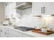 Gourmet kitchen showcasing white cabinets, stainless steel appliances, and sleek gas cooktop at 144 Sandy Bend Ln, Summerville, SC 29486