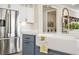 Close-up of the kitchen island featuring a farmhouse sink, stainless steel fridge, and white countertops at 144 Sandy Bend Ln, Summerville, SC 29486