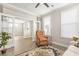 Living room view through double doors showcasing a leather chair, white sofa and decorative rug at 144 Sandy Bend Ln, Summerville, SC 29486