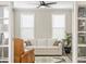 Well-lit living room with a white sofa, area rug, and a glimpse of a leather chair through french doors at 144 Sandy Bend Ln, Summerville, SC 29486