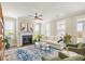 Cozy living room featuring a fireplace, ceiling fan and lots of natural light at 144 Sandy Bend Ln, Summerville, SC 29486