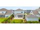 Rear exterior of a two-story home, showcasing a screened porch, a brick paver patio, and a fenced backyard at 144 Sandy Bend Ln, Summerville, SC 29486