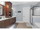 A bathroom featuring a double sink vanity, a soaking tub, and a glass-enclosed shower at 147 Musket Loop, Summerville, SC 29483