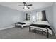 This bedroom has light-blue walls, two beds, and a ceiling fan at 147 Musket Loop, Summerville, SC 29483