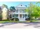Charming two-story home with double front porches, red front door and beautifully landscaped yard at 147 Musket Loop, Summerville, SC 29483
