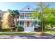 Charming two-story home with double front porches, red front door and beautifully landscaped yard at 147 Musket Loop, Summerville, SC 29483