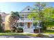 Charming two-story home with double front porches, red front door and beautifully landscaped yard at 147 Musket Loop, Summerville, SC 29483
