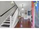 Inviting foyer with hardwood floors, stairway, and decorative table at 147 Musket Loop, Summerville, SC 29483