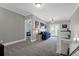 Upstairs hallway with carpet, a cozy couch, and doors leading to the bedrooms at 147 Musket Loop, Summerville, SC 29483