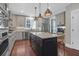 Bright kitchen boasts a large center island with bar seating, stainless appliances, and ample storage space at 147 Musket Loop, Summerville, SC 29483