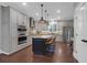 An inviting kitchen features stainless steel appliances, custom cabinetry, and a large island with seating at 147 Musket Loop, Summerville, SC 29483