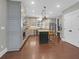 A spacious kitchen with stainless appliances, granite countertops, pendant lighting, and hardwood flooring at 147 Musket Loop, Summerville, SC 29483