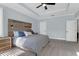 This main bedroom includes a wooden headboard, a ceiling fan, and two bedside reading lamps at 147 Musket Loop, Summerville, SC 29483
