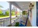 Comfortable porch with white railings, patriotic decorations, and neighborhood views at 147 Musket Loop, Summerville, SC 29483