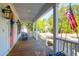 Comfortable porch with white railings, rocking chairs, patriotic decorations, and neighborhood views at 147 Musket Loop, Summerville, SC 29483