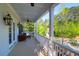 Spacious porch with ceiling fans, vintage lighting, comfortable seating, and neighborhood views at 147 Musket Loop, Summerville, SC 29483