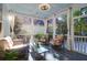 Cozy screened porch with comfortable seating, decorative rug, and natural light creating a relaxing outdoor space at 147 Musket Loop, Summerville, SC 29483