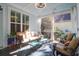 A serene screened-in porch featuring comfortable seating and a tranquil view of the surrounding greenery at 147 Musket Loop, Summerville, SC 29483