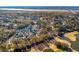 Stunning aerial view of a golf course community with waterway access and beautiful homes nestled among mature trees at 1504 Galloway Ln, Charleston, SC 29412