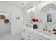 This bathroom features double sinks, white cabinetry, gold hardware, and shiplap walls at 1504 Galloway Ln, Charleston, SC 29412