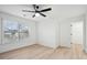 Light-filled bedroom with wood-look floors, a ceiling fan and a walk-in closet at 1504 Galloway Ln, Charleston, SC 29412