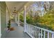 Inviting front porch featuring classic columns, pendant lighting, and views of the lush surrounding greenery at 1504 Galloway Ln, Charleston, SC 29412
