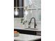 This kitchen sink features matte black fixtures, a white countertop and a view of the backyard at 1504 Galloway Ln, Charleston, SC 29412