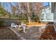 Paver patio with outdoor chairs, fire pit, and wooded view provides a relaxing retreat at 1504 Galloway Ln, Charleston, SC 29412